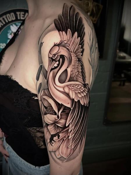 Blackwork crane and flower tattoo by @gempintattoo