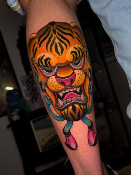 Traditional tiger mask tattoo by @taish.one