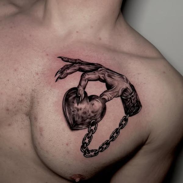 Realism hand holding heart tattoo by @gekodivine