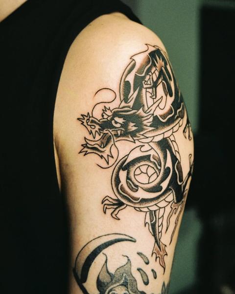 Traditional dragon tattoo by @geonik.tattoo