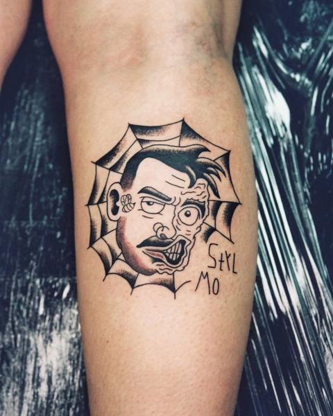 Traditional distorted face tattoo by @geonik.tattoo