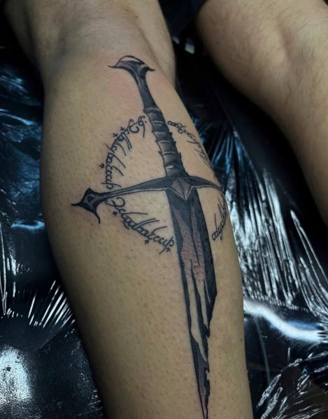 Blackwork sword with script tattoo by @lahaine_tattoo