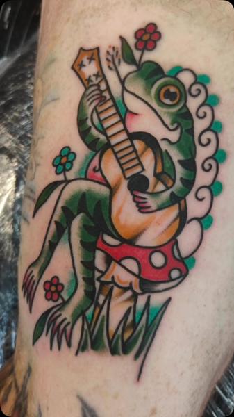 Traditional frog with guitar tattoo by @gnarly_.charlie_