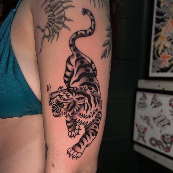 Traditional crawling tiger tattoo by @bad_news_tattoos