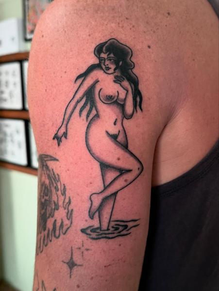 Traditional nude woman tattoo by @bad_news_tattoos