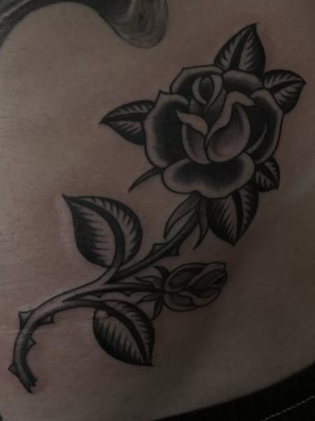 Traditional black rose tattoo by @bad_news_tattoos