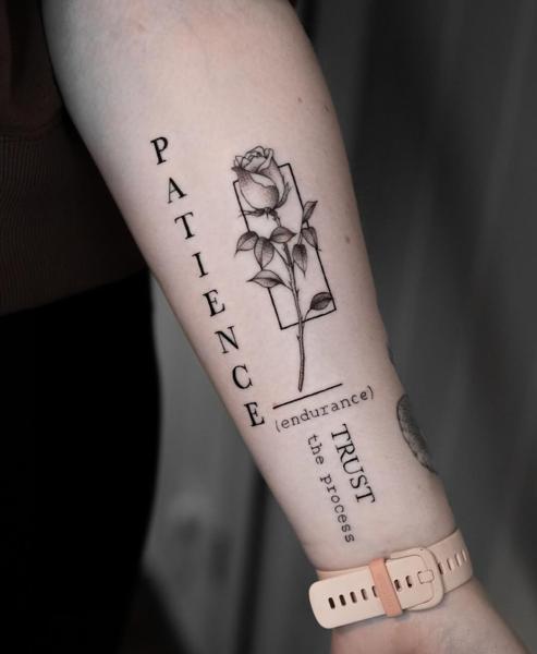 Fine line rose with text tattoo by @griff.tattoo