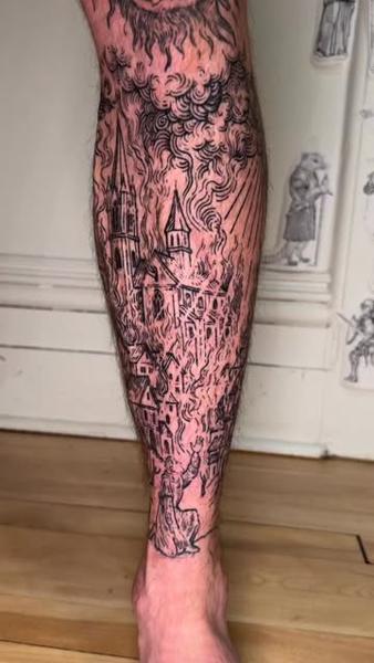 Illustrative burning cityscape tattoo by @goh_w_h.tattoo