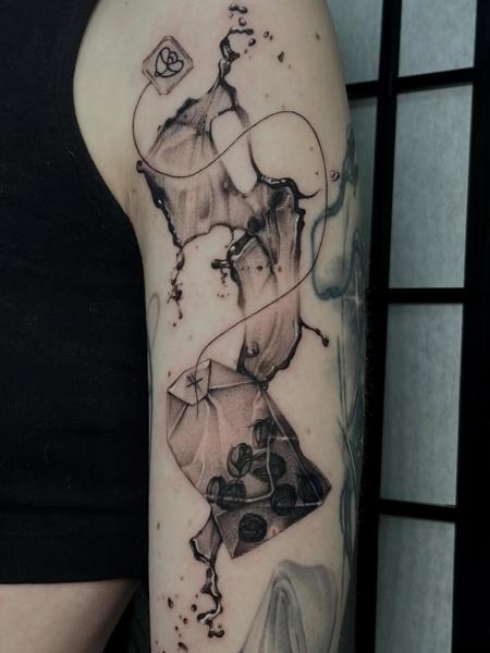 Realism tea bag tattoo by @mystickyfingers_