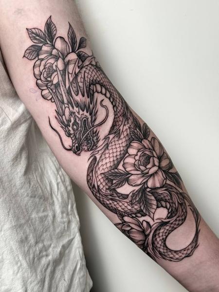 Blackwork dragon with flowers tattoo by @harrisonb_tattoos