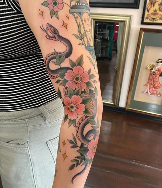 Traditional floral snake tattoo by @helenbrowntattoo13