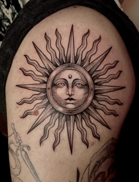 Blackwork sun face tattoo by @helle.ink