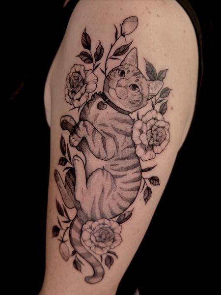 Blackwork cat with flowers tattoo by @helle.ink