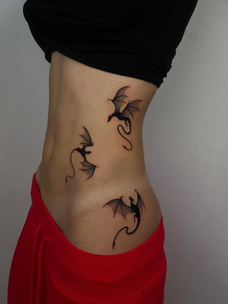 Fine line flying dragons tattoo by @himiko.ink