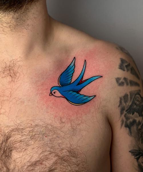 Traditional blue swallow tattoo by @himiko.ink