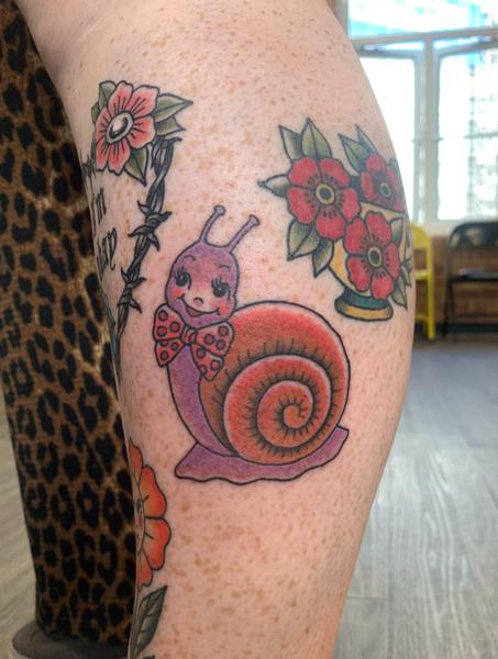 Traditional cute snail tattoo by @hollielimertattoo
