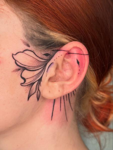 Fine Line floral ear tattoo by @inx.tattoo