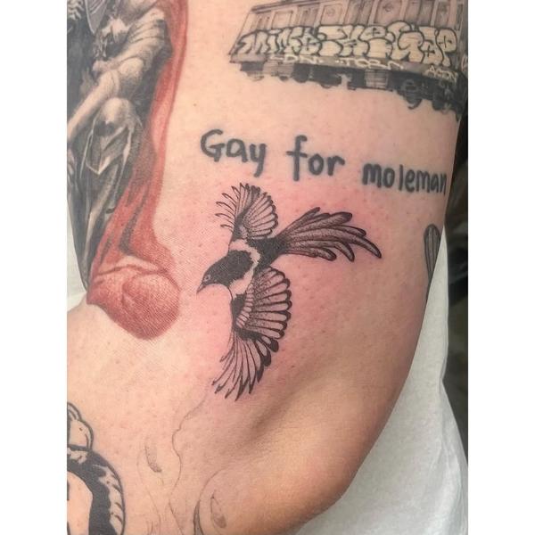Blackwork flying magpie tattoo by @izit_ink
