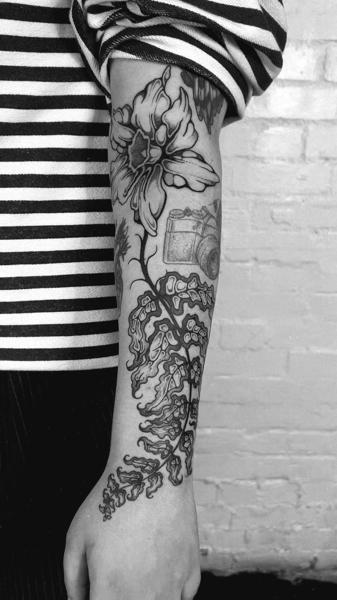 Blackwork floral camera tattoo by @jackhowardtattoo