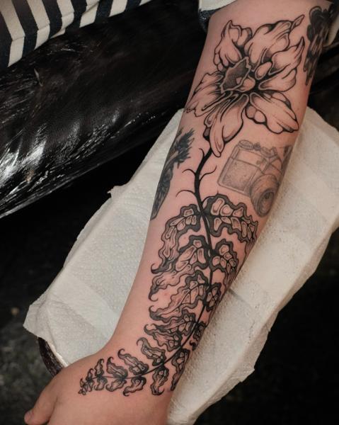 Blackwork floral design tattoo by @jackhowardtattoo
