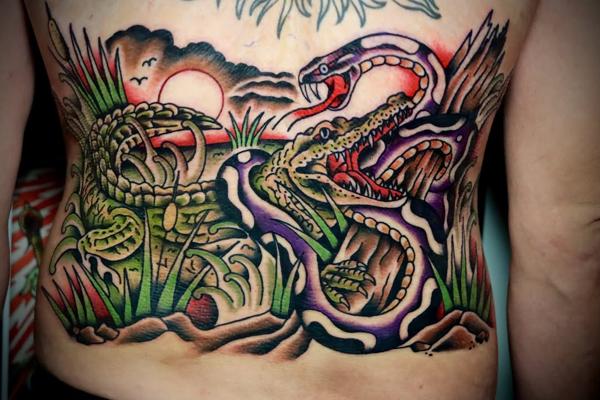Traditional alligator snake tattoo by @straats_tatts