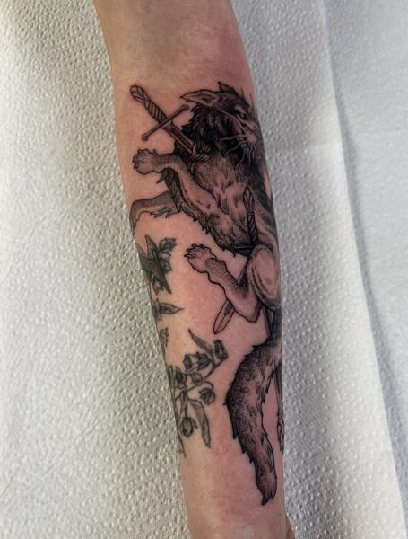Illustrative blackwork wounded wolf swords tattoo by @callmenighthawkk