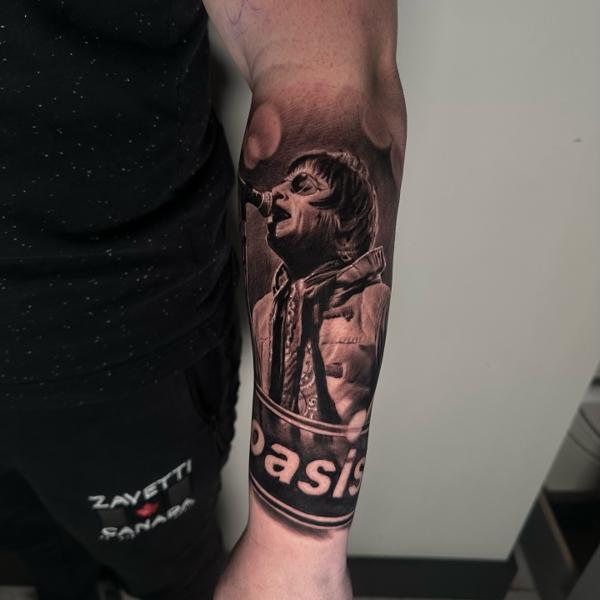 Realism singer portrait tattoo by @jodiestarktattoo