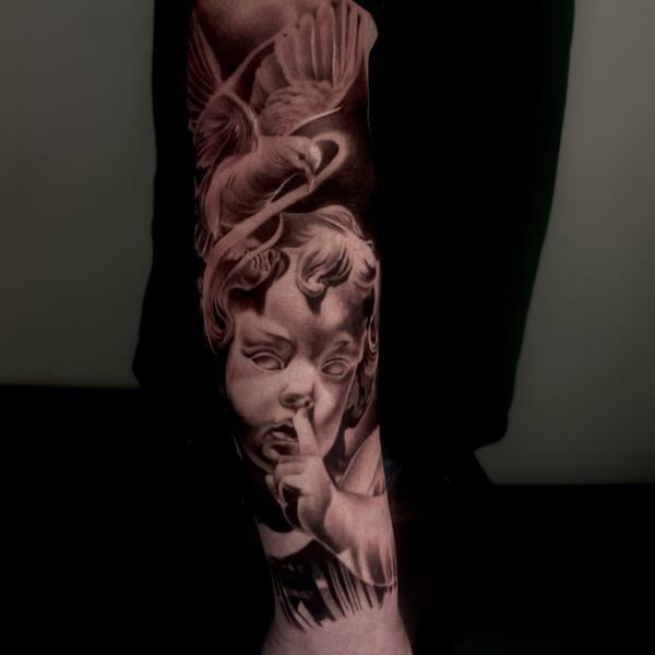 Realism cherub and bird tattoo by @jodiestarktattoo