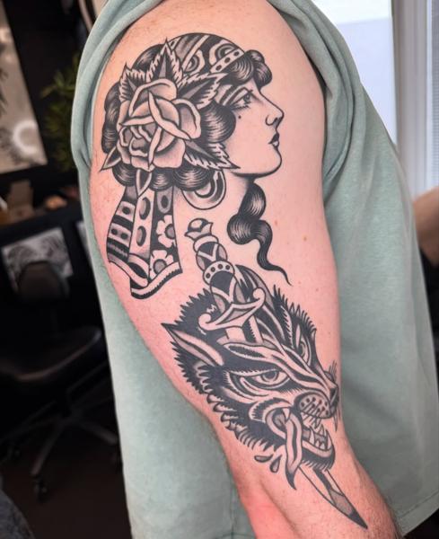 Traditional woman and wolf tattoo by @joegarey_tattoo