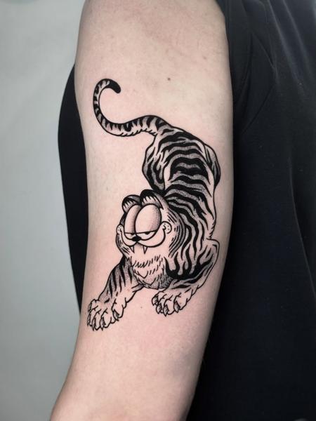 Illustrative cartoon tiger tattoo by @outofprison_