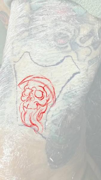 Linework skull with hood tattoo by @heartanddagger.tattoo