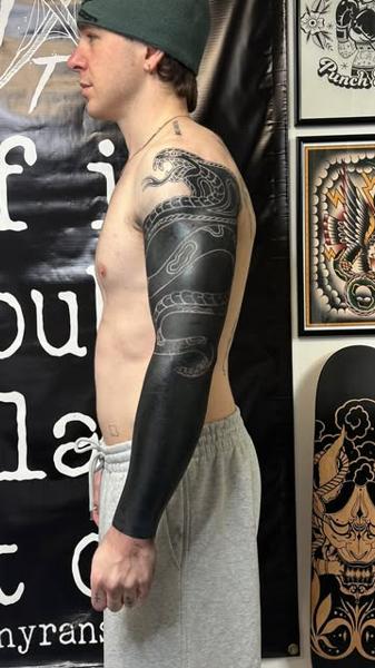 Blackwork snake sleeve tattoo by @jonnyransomtattoo