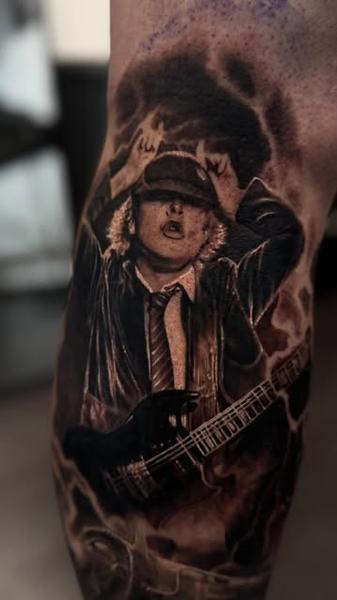 Realism guitarist portrait tattoo by @jtatattoos