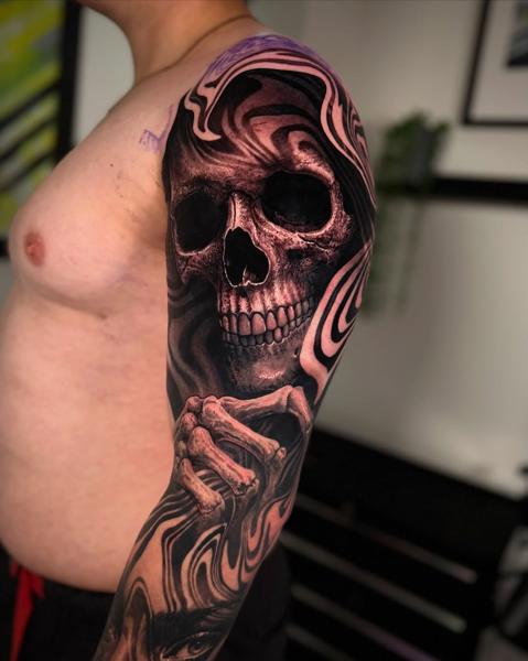 Realism swirling skull tattoo by @jtatattoos