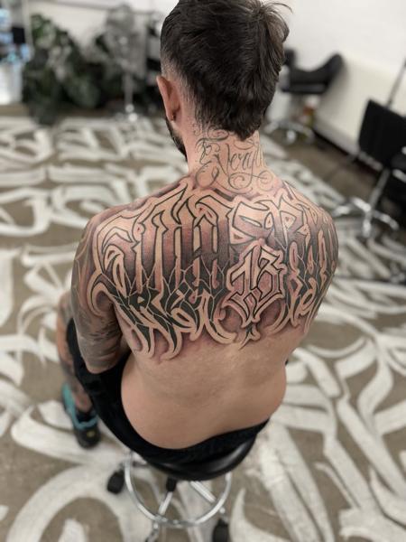 Blackwork tribal lettering tattoo by @niorkz