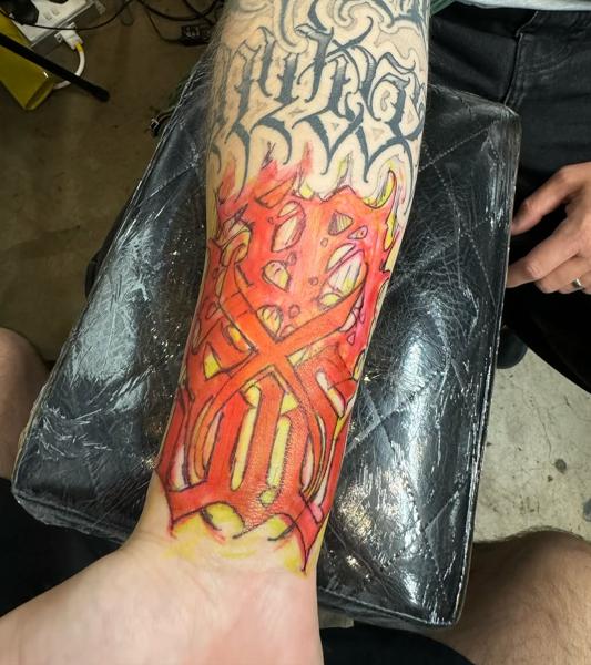 Color realism flaming symbol tattoo by @niorkz