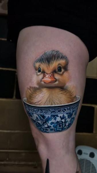 Realism duckling in teacup tattoo by @jurgismikalauskas
