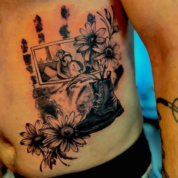 Illustrative blackwork framed photo boot tattoo by @j_c_tattoos