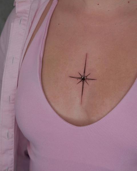 Fine line sparkle star tattoo by @karolina_tattooer