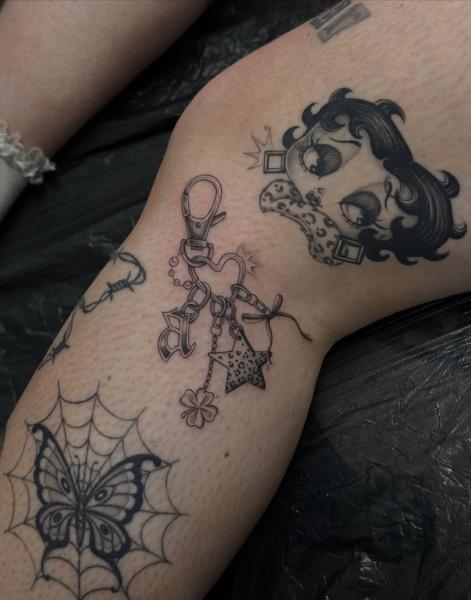 Fine line charm bracelet tattoo by @katcorneytattoo