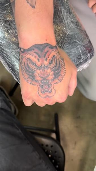 Traditional tiger head tattoo by @katcorneytattoo