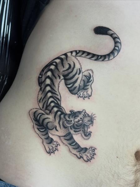 Traditional crouching tiger tattoo by @katcorneytattoo