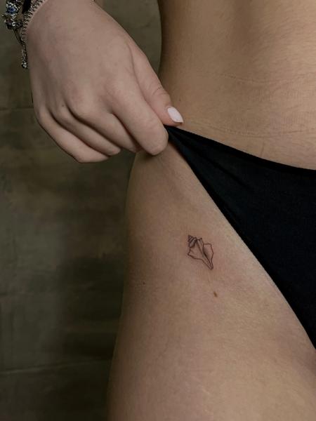 Fine line seashell tattoo by @kat_blink_tattoo