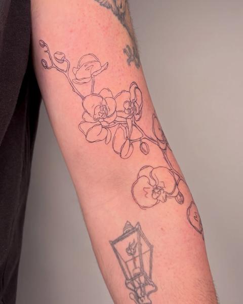 Fine line orchid flowers tattoo by @nevermind.tattoos