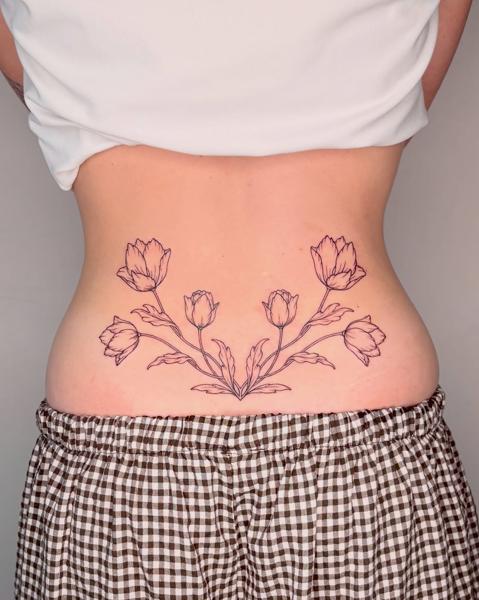 Fine line floral design tattoo by @nevermind.tattoos