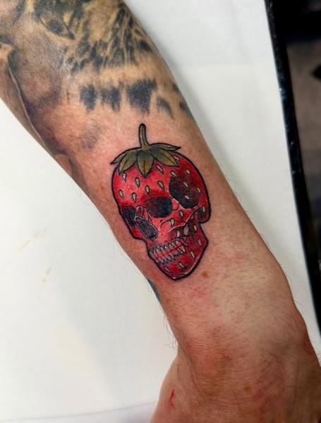 Traditional strawberry skull tattoo by @katysars