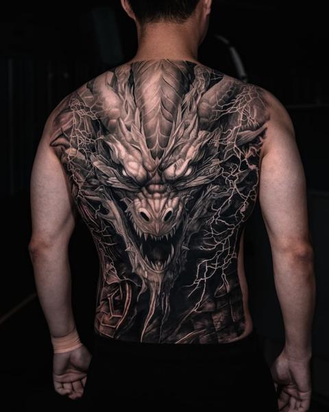 Realism dragon tattoo by @kazin_tattooer