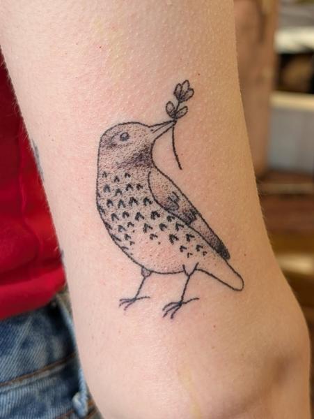 Fine line bird with flower tattoo by @kellyneedles