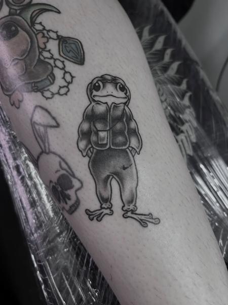 Illustrative frog character tattoo by @kerieedwardstattoo