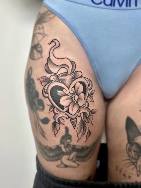 Blackwork floral heart tattoo by @kira_ludwig_tattoos
